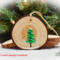 Acrylic painting on the back of a wood slice ornament at Cove Creek Photography.